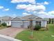 Inviting home with well-kept landscaping, brick driveway, and a two-car garage in a serene neighborhood setting at 3711 Plymouth Dr, Winter Haven, FL 33884