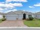 Charming single-Gathering home with a brick driveway, a well-manicured lawn, and a neutral-colored exterior at 3711 Plymouth Dr, Winter Haven, FL 33884