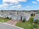 Charming gray home with a three car garage, brick driveway and landscaped front yard at 3711 Plymouth Dr, Winter Haven, FL 33884