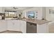 Spacious kitchen with stainless steel dishwasher, ample counter space, and built-in media center at 3711 Plymouth Dr, Winter Haven, FL 33884
