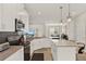 Kitchen featuring white cabinetry, stainless steel appliances, island with seating, and open layout at 3711 Plymouth Dr, Winter Haven, FL 33884