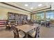 Clubhouse Library with a book-lined wall and cozy seating around tables at 3711 Plymouth Dr, Winter Haven, FL 33884
