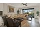 Cozy living room with comfortable seating, tile floors, and a view of the screened-in lanai at 3711 Plymouth Dr, Winter Haven, FL 33884