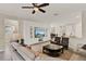 Spacious living room with a large entertainment center, tile flooring, and comfortable seating at 3711 Plymouth Dr, Winter Haven, FL 33884