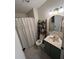 Cozy bathroom with shower/tub combo, decorated shelves, and a vanity with a mirror at 4024 Canal Rd, Lake Wales, FL 33898