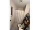 Modest bathroom with neutral walls, a shower with a white curtain, and tiled floors at 4024 Canal Rd, Lake Wales, FL 33898