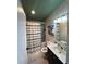 Bright bathroom with a shower and patterned curtain, vanity and a dark green ceiling at 4024 Canal Rd, Lake Wales, FL 33898