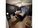 Dark bedroom features a bed, massage table, ceiling fan, and hardwood floors at 4024 Canal Rd, Lake Wales, FL 33898