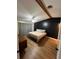 Bedroom boasts wood-look floors, ceiling fan, and modern accent wall at 4024 Canal Rd, Lake Wales, FL 33898