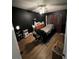 Dark bedroom features a bed, massage table, ceiling fan, and hardwood floors at 4024 Canal Rd, Lake Wales, FL 33898