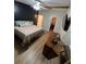 Bedroom featuring a television, ceiling fan, wood beam, wood floor, and warm colors at 4024 Canal Rd, Lake Wales, FL 33898