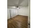 Spacious bedroom with a vaulted ceiling, wood floors, and natural light from a window with curtains at 4024 Canal Rd, Lake Wales, FL 33898