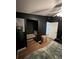 Dark bedroom features a unique nook with seating and hardwood floors at 4024 Canal Rd, Lake Wales, FL 33898
