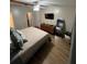 Bedroom with ceiling fan, wood-look floors, and doorway to bathroom at 4024 Canal Rd, Lake Wales, FL 33898