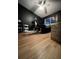 Dark bedroom features a bed, massage table, ceiling fan, and hardwood floors at 4024 Canal Rd, Lake Wales, FL 33898