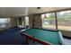 Spacious game room featuring a pool table, blue carpeting, and natural light from the surrounding windows at 4024 Canal Rd, Lake Wales, FL 33898
