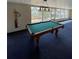 Well-lit game room features blue carpet, a pool table, and multiple windows at 4024 Canal Rd, Lake Wales, FL 33898