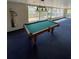 Bright game room featuring a pool table with wood trim, a vintage-style light fixture, and views of the backyard at 4024 Canal Rd, Lake Wales, FL 33898
