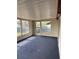 Well-lit game room with access to the outdoors, large windows, and blue flooring at 4024 Canal Rd, Lake Wales, FL 33898