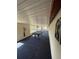 Long game room with a pool table, large windows, blue carpeting, and ample space for relaxation at 4024 Canal Rd, Lake Wales, FL 33898