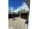 Garage exterior with a barbecue pit, fence and the exterior of a home under a partly cloudy sky at 4024 Canal Rd, Lake Wales, FL 33898