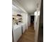 This hallway has a laundry room, wood-look vinyl flooring, and neutral paint at 4024 Canal Rd, Lake Wales, FL 33898
