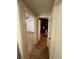 Hallway with wood-look flooring and doorways leading to various rooms, showcasing an open layout at 4024 Canal Rd, Lake Wales, FL 33898