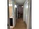 Hallway with view to bathroom and living room with washer and dryer hookups at 4024 Canal Rd, Lake Wales, FL 33898