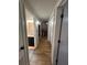Hallway view of bathroom with vanity and dark cabinets plus the laundry area with washer and dryer at 4024 Canal Rd, Lake Wales, FL 33898