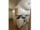 The kitchen features white cabinets and appliances, and wood-look vinyl flooring at 4024 Canal Rd, Lake Wales, FL 33898