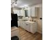 The kitchen has white cabinets and appliances, double sinks, and wood-look vinyl flooring at 4024 Canal Rd, Lake Wales, FL 33898
