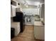 Cozy kitchen features white cabinets, appliances, track lighting, and wood-look vinyl flooring at 4024 Canal Rd, Lake Wales, FL 33898