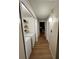 Bright laundry room with white appliances and shelving for storage, plus modern flooring and hallway access at 4024 Canal Rd, Lake Wales, FL 33898