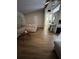 Open living room area with vaulted ceiling, new flooring, comfortable couch, and hallway to the kitchen at 4024 Canal Rd, Lake Wales, FL 33898