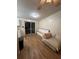 Open living area featuring wood floors, a comfortable couch, and sliding glass doors at 4024 Canal Rd, Lake Wales, FL 33898