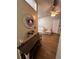 Entryway with wood floors, accent mirror, key rack and a glimpse of the living area at 4024 Canal Rd, Lake Wales, FL 33898