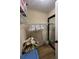 Walk-in closet with wire shelving, mirror and wood-look flooring to provide ample storage at 4024 Canal Rd, Lake Wales, FL 33898