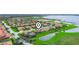 Aerial view of a residential community featuring well-maintained landscaping and a pond at 4073 Sable Loop Dr, Lake Wales, FL 33859