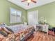 Bedroom featuring a bed with colorful quilt, a desk, and a window with shutters at 4073 Sable Loop Dr, Lake Wales, FL 33859