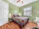 Bedroom featuring a cozy bed with colorful quilt, with a large window for natural light at 4073 Sable Loop Dr, Lake Wales, FL 33859