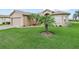 Well-maintained front yard with lush grass, landscaping and charming curb appeal at 4073 Sable Loop Dr, Lake Wales, FL 33859