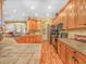 Open kitchen featuring tile countertops, wood cabinets, recessed lighting, and a breakfast bar at 4073 Sable Loop Dr, Lake Wales, FL 33859
