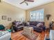 Inviting living room with hardwood floors, natural light, and comfortable leather seating at 4073 Sable Loop Dr, Lake Wales, FL 33859