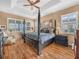 Spacious main bedroom with a four-poster bed and large windows at 4073 Sable Loop Dr, Lake Wales, FL 33859