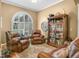 Comfortable sitting room featuring two leather chairs and a beautiful arched window at 4073 Sable Loop Dr, Lake Wales, FL 33859