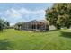 Wide backyard with screened in lanai and pool, perfect for relaxing and entertaining at 415 Ruby Lake Pl, Winter Haven, FL 33884