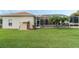 Spacious backyard with a screened-in pool, lush green lawn, and privacy at 415 Ruby Lake Pl, Winter Haven, FL 33884
