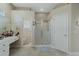 Bright bathroom featuring a walk-in shower, vanity, and separate toilet area at 415 Ruby Lake Pl, Winter Haven, FL 33884