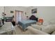 Cozy bedroom featuring a comfortable bed, sofa, and natural light at 415 Ruby Lake Pl, Winter Haven, FL 33884