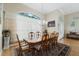 Formal dining room featuring hardwood floors, a large window, a chandelier, and seating for eight at 415 Ruby Lake Pl, Winter Haven, FL 33884